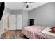 Bedroom with wood floors, ceiling fan, security safe and closet at 5957 Olivine Falls Ave, Las Vegas, NV 89130