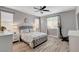 Bedroom with natural light, a ceiling fan, modern decor, and wood-look floors at 5957 Olivine Falls Ave, Las Vegas, NV 89130