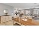 Open dining and living area with a dining table, buffet, and view into the modern kitchen at 5957 Olivine Falls Ave, Las Vegas, NV 89130