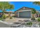 Lovely front exterior showcasing a spacious driveway and well-maintained landscaping at 5957 Olivine Falls Ave, Las Vegas, NV 89130