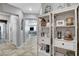 Elegant hallway with neutral tones, tile flooring, and built-in shelving at 5957 Olivine Falls Ave, Las Vegas, NV 89130