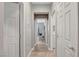 Neutral hallway with multiple doorways, tiled floors, and access to various rooms within the house at 5957 Olivine Falls Ave, Las Vegas, NV 89130