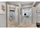 Bright hallway featuring tile floors, arched doorways, and views of the living area at 5957 Olivine Falls Ave, Las Vegas, NV 89130