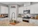 Modern kitchen features granite counters, stainless appliances, and white cabinetry at 5957 Olivine Falls Ave, Las Vegas, NV 89130