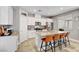 Modern kitchen features white cabinets, granite countertops, stainless steel appliances, and seating at the island at 5957 Olivine Falls Ave, Las Vegas, NV 89130