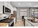 Bright kitchen featuring stainless steel appliances, granite counters, and an open design at 5957 Olivine Falls Ave, Las Vegas, NV 89130