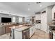 Open concept kitchen features a spacious island and opens to the living and dining areas at 5957 Olivine Falls Ave, Las Vegas, NV 89130