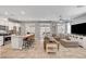 Bright, open living room and kitchen area with tile floors and modern finishes throughout at 5957 Olivine Falls Ave, Las Vegas, NV 89130