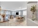 Bright and open living area with tile floors, neutral colors, and a view of the backyard at 5957 Olivine Falls Ave, Las Vegas, NV 89130