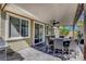 Inviting covered patio with a dining table, fan, and grill, ideal for outdoor dining at 5957 Olivine Falls Ave, Las Vegas, NV 89130