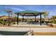 Community picnic pavilion with picnic tables and barbecue grills, perfect for gatherings at 5957 Olivine Falls Ave, Las Vegas, NV 89130