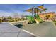 Community playground featuring slides, climbing structures, and a covered play area at 5957 Olivine Falls Ave, Las Vegas, NV 89130