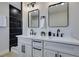 Modern bathroom with double sink vanity, black fixtures, and tiled shower at 6100 Fawn Cir, Las Vegas, NV 89107