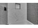 Modern bath and shower feature white and gray tile at 6100 Fawn Cir, Las Vegas, NV 89107