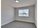 A simple bedroom features carpet, a window and white walls at 6100 Fawn Cir, Las Vegas, NV 89107