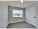 Neutral bedroom with carpet, a window, and a white door at 6100 Fawn Cir, Las Vegas, NV 89107