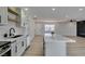 Open concept kitchen with island, stainless appliances, leading to living area with fireplace at 6100 Fawn Cir, Las Vegas, NV 89107