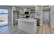 Updated kitchen featuring stainless steel appliances, a center island, and access to the backyard at 6100 Fawn Cir, Las Vegas, NV 89107
