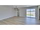 Bright, open living area showcasing wood-look tile floors and sliding glass doors to the backyard at 6100 Fawn Cir, Las Vegas, NV 89107