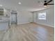 Living room featuring light grey walls, sleek flooring, and access to the kitchen and exterior at 6100 Fawn Cir, Las Vegas, NV 89107