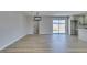 Inviting living room with sliding glass door leading to the backyard and wood-look flooring at 6100 Fawn Cir, Las Vegas, NV 89107