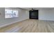 Well-lit open-concept living room featuring sleek flooring and a modern black accent wall with a built-in fireplace at 6100 Fawn Cir, Las Vegas, NV 89107
