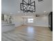 Open-concept living space with wood-look tile flooring, updated lighting, and modern finishes at 6100 Fawn Cir, Las Vegas, NV 89107
