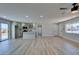 Spacious living area with views of the kitchen featuring an island and modern appliances at 6100 Fawn Cir, Las Vegas, NV 89107