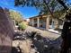 Well-maintained backyard with rock landscaping, lawn, patio and a covered porch area, perfect for outdoor entertaining at 6134 Burleson Ranch Rd, Las Vegas, NV 89131