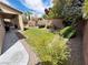 Backyard with lush greenery and a brick wall border at 6134 Burleson Ranch Rd, Las Vegas, NV 89131