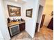 Cozy bar area featuring a wine fridge, granite countertop, sink, and dark wood cabinets at 6134 Burleson Ranch Rd, Las Vegas, NV 89131