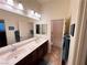 Well-lit bathroom featuring a double sink vanity with modern fixtures and tile flooring at 6134 Burleson Ranch Rd, Las Vegas, NV 89131