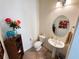 Powder room featuring a pedestal sink, decorative vases, and a framed picture at 6134 Burleson Ranch Rd, Las Vegas, NV 89131