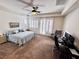 Spacious bedroom features a king bed, light blue comforter set, ceiling fan, and abundant natural light at 6134 Burleson Ranch Rd, Las Vegas, NV 89131