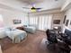 Bright bedroom with carpet, ceiling fan, two twin beds, and natural light from shuttered windows at 6134 Burleson Ranch Rd, Las Vegas, NV 89131