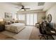 Bedroom with a tray ceiling, plantation shutters, and a work space at 6134 Burleson Ranch Rd, Las Vegas, NV 89131