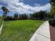 Expansive green common area featuring a walking path, mature trees, and a pergola at 6134 Burleson Ranch Rd, Las Vegas, NV 89131