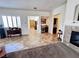 Bright hallway with tile floors, shutters, and neutral paint, leading to various rooms in the home at 6134 Burleson Ranch Rd, Las Vegas, NV 89131