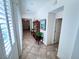 Hallway with light tile floors and white walls, leading to various rooms at 6134 Burleson Ranch Rd, Las Vegas, NV 89131