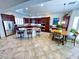 Gourmet kitchen with granite counters, stainless appliances, island with bar seating, and adjacent breakfast nook at 6134 Burleson Ranch Rd, Las Vegas, NV 89131
