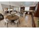 Open kitchen and dining area with dark wood cabinets, stainless steel appliances, and an island at 6134 Burleson Ranch Rd, Las Vegas, NV 89131