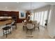 Bright kitchen with dark wood cabinets, stainless steel appliances, and plantation shutters at 6134 Burleson Ranch Rd, Las Vegas, NV 89131