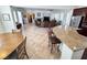An open living space with tiled floors, a fireplace, and lots of natural light from the windows at 6134 Burleson Ranch Rd, Las Vegas, NV 89131