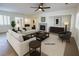 Bright living room features a fireplace, neutral paint, ceiling fan, and tile flooring at 6134 Burleson Ranch Rd, Las Vegas, NV 89131