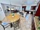 Bright living and dining area with dark wood cabinets and an island at 6134 Burleson Ranch Rd, Las Vegas, NV 89131