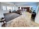 Open-concept layout with carpeted living room and tiled dining area and kitchen at 6134 Burleson Ranch Rd, Las Vegas, NV 89131