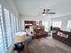 Bright and airy living room with plush sofas and ample natural light from shuttered windows at 6134 Burleson Ranch Rd, Las Vegas, NV 89131