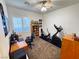 Functional office space with a built-in desk, exercise equipment, and bright lighting at 6134 Burleson Ranch Rd, Las Vegas, NV 89131