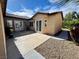 Extended outdoor patio featuring low-maintenance landscape and access to the main residence through multiple glass doors at 6134 Burleson Ranch Rd, Las Vegas, NV 89131