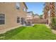 Backyard featuring an outdoor dining area, landscaped greenery and a privacy wall at 6390 Whispering Clouds Ct, Las Vegas, NV 89141